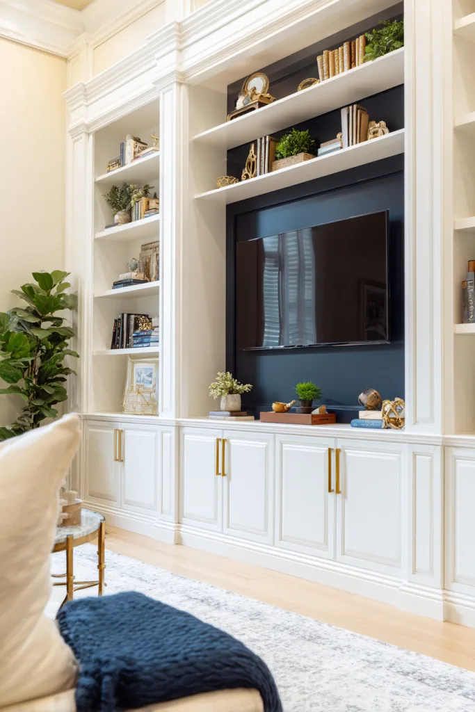 Floor-to-ceiling built-in cabinetry surrounding a mounted TV