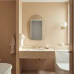 neutral bathroom inspo with warm beige tile, white oak, and brushed nickel